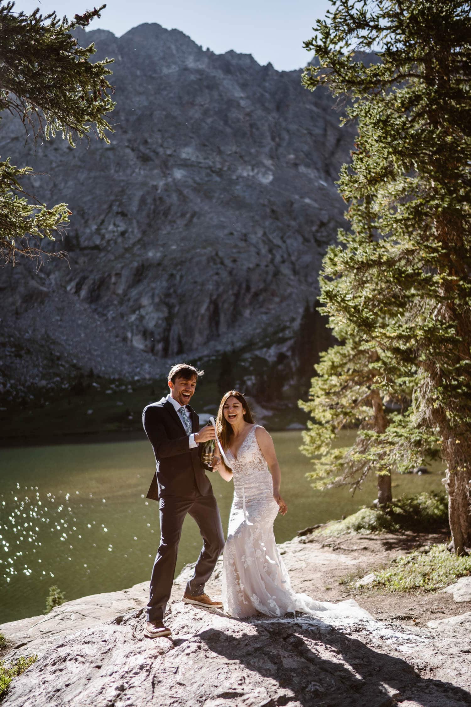 Bride and Groom Popping Champagne Grand Lake Colorado Elopement